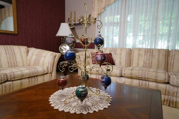 Collection of Terry Redlin ceramic Christmas ornaments and stand. 