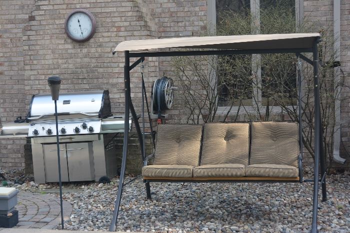 Comfortable outdoor swing in great condition. Also, stainless steel gas grill and outdoor clock.