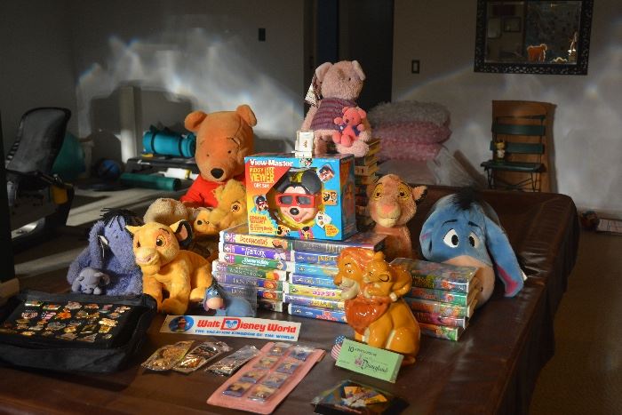 Some of the Disney collectibles including Disney trading pins, a vintage Disneyland ride coupon book, blue diamond VCR tapes and an unopened Disney ViewMaster.