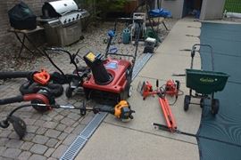 Outdoor equipment. Newer Toro snowblower, Black and Decker electric blower/leaf vacuum, Homelite gas blower, gas weed wacker, gas edger with extra new blades, utility light and lawn fertilizer spreader.