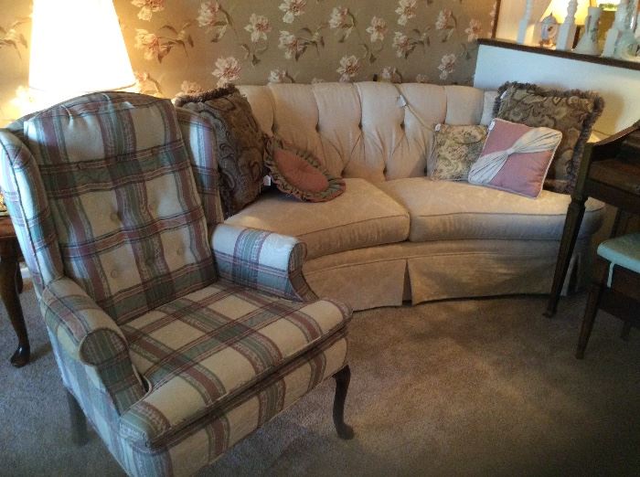 Queen Anne wingback chair and another sofa with rounded and tufted back. 