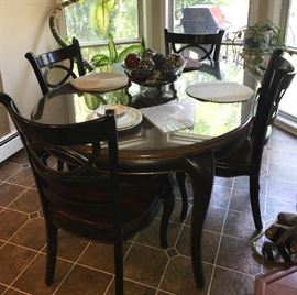 This oval dining room set currently has a leaf in the center, it can also be ROUND.  Includes glass top for both oval and round configurations as well as 4 gorgeous high end chairs. 