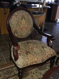 Carved wood, brocade arm chair