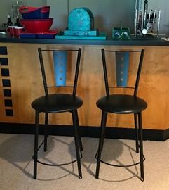 Pair of modern bar stools. Along with lots of bar items. 