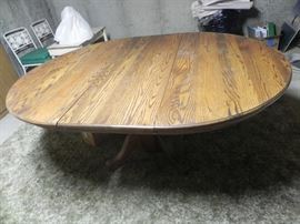 Oak pedestal table with leaf and 6 matching chairs. $250.00