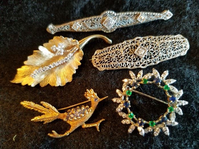 14 kt. gold leaf broach with diamonds,                     Victorian 14 kt. white gold bar broach with 3 diamonds, Victorian 10 kt. white gold bar broach with a single diamond,  14 kt. gold road runner pin with diamonds, 18 kt. white gold wreath broach with diamonds, emeralds, & sapphires 