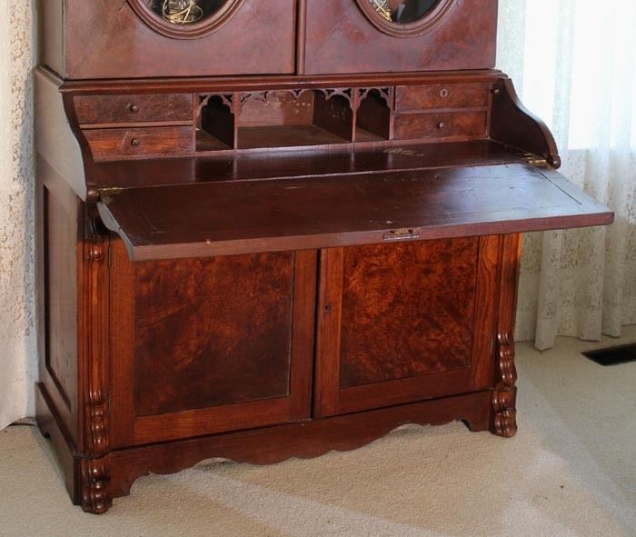 038d  Walnut Victorian secretary bookcase with oval glass doors and slant front, 93 in. T, 49 in. W, 24 in. D.