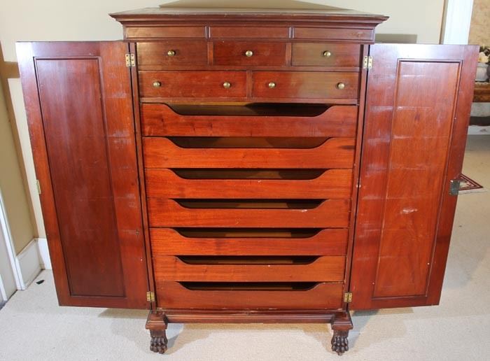 060c  Mahogany Empire gentlemens chest with fitted drawers, column front and claw feet, 64 in. T, 42 in. W, 27 in. D.