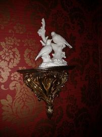 Porcelain bird figurine on gilt decorated wall sconce
