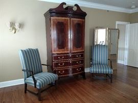 Armoire and a pair of open armchairs