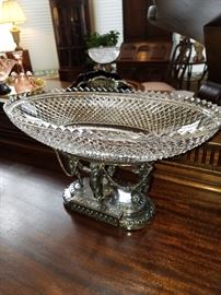 One of an almost matching pair of cut glass oval bowls on metal bases.  This one is silver plated.