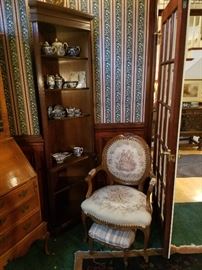 The other corner cabinet and a fancy chair and ottoman