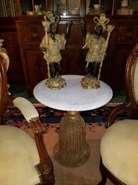 Tassel base metal table with marble top displaying 19th century matched pair of blackamoor figures