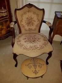 Floral upholstered arm chair along with an oval footstool