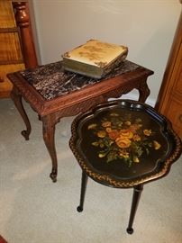 Marble top stand with photo album behind a papier mache tray fitted into a base to use as a stand