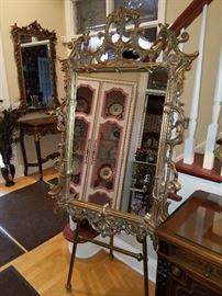 Gilt frame mirror displayed on a brass easel 
