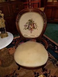 Carved medallion back chair with needlepoint back