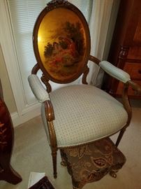 Gilt oval back arm chair with painted scene