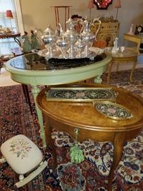 Marble top green oval table displaying a silver plated Victorian era tea set.  Front: Oval table by Baker