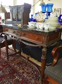 Side table/server which matches long buffet and dining table in this room.  Servers have black marble tops.  Set of dishes on top is Royal Copenhagen
