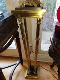 One of two brass and marble stands.  Not an optical illusion...the brass supports angle outward.