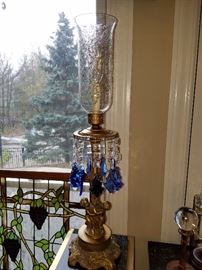 One of two ornate figural lamps with blue prisms and etched glass shades