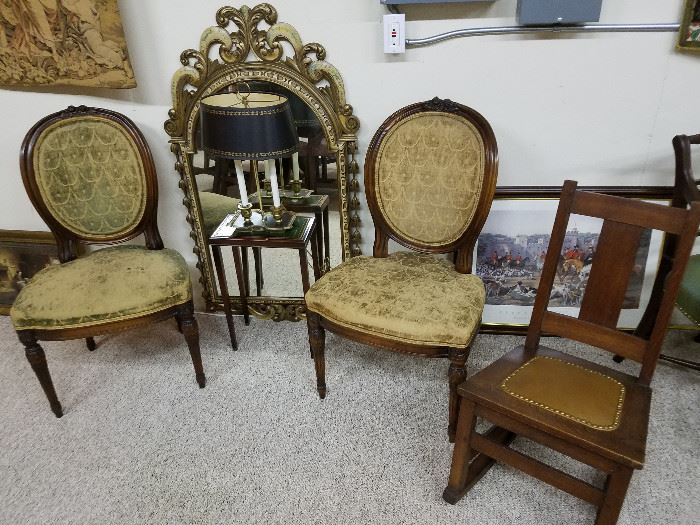 Pair of chairs, mirror, and oak rocker in the storeroom