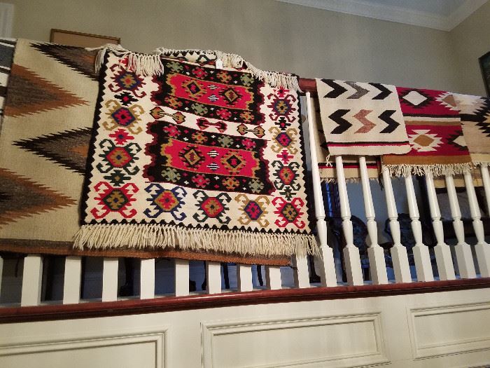 Southwest rugs displayed on the balcony railing