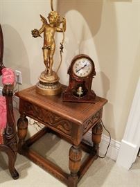 Swinging girl clock appears to have stopped working.  Carved "Joint" stool appears to be a 1920's rendition of an much older form