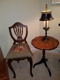 Youth style shield back chair beside a Hitchcock table with tole lamp