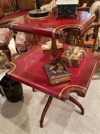 Curled red leather covered two-tier square stand.  Quite unusual!