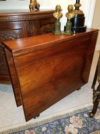 Side view of rosewood drop-leaf table