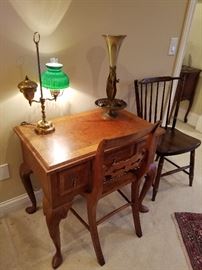 Small desk or dressing table (no mirror) with student lamp and art glass vase in stand.