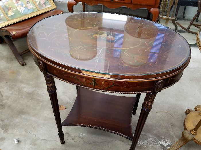 Paint decorated oval table, with loss to front edge