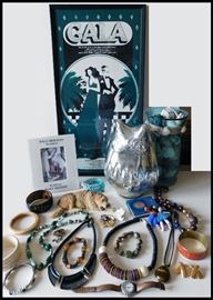 Jewelry including a Unakite bracelet plus other treasures and in the background a gala poster from West Des Moines, Iowa.