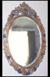 Oval mirror with grape leaves. Purchased at Antique Restorations. 24" x 40".