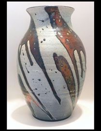Raku pot with brilliant copper glazes. Approximately twelve inches tall. It is much more vivid and shiny than the photo shows.