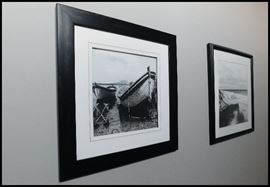 Sampling of framed black and white photographs. Various subjects including boats.