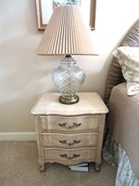 One of a pair of country French style night stands and cut glass lamps