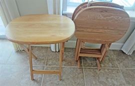 Set of four oak, oval TV trays and holder