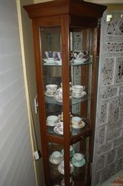 Three sided wood and glass curio cabinet
