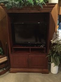 Entertainment center with retractable doors