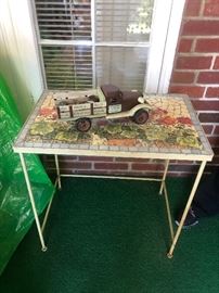 Stone and metal patio table with a little toy truck a top