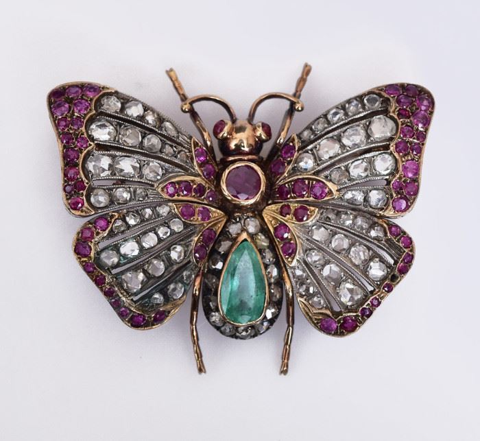 Victorian 18k Gold Butterfly Brooch
set with approximately .50 ct emerald,
71 rose cut diamonds, approximately 3.55 ct tw
and 66 round cut rubies, approximately 2.0 ct tw
set in a silver topped 18k gold mounting
2" diameter, 16 dwt gross