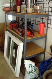two chain saws, new never used window, metal four shelf rack and misc.