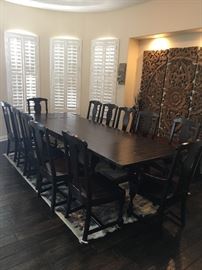 Thick solid wood dining table with 2 extension leaves and  12 chairs.                                                                                        main table - W/42" x L/76"                                                            one leaf - 42 x 23