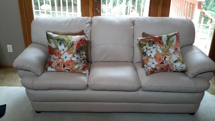 Beautiful off-white faux leather sofa in like-new condition. $150.00