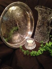 Round silver plate tray, crystal pitcher, and candle holder