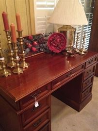 Nine-drawer desk; brass candle holders and lamp; cinnabar plate