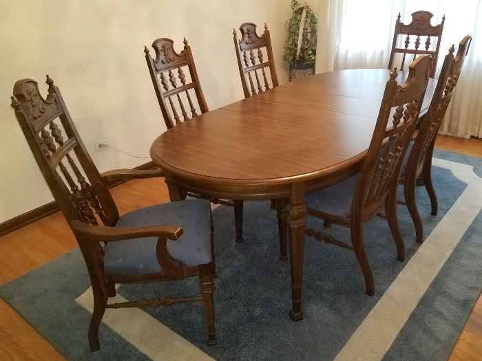 Dining room table and six chairs. Blue floor rug